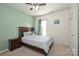 Cozy bedroom featuring a bed, a nightstand, a ceiling fan, and a window, offering a relaxing retreat at 1035 Ivey Ct, Fort Mill, SC 29707