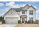 Charming two-story home featuring a two-car garage and beautifully landscaped front yard at 1035 Ivey Ct, Fort Mill, SC 29707