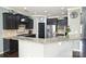 Well-equipped kitchen with dark cabinets, stainless steel appliances and granite countertops at 1035 Ivey Ct, Fort Mill, SC 29707