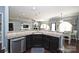 Bright kitchen featuring a breakfast bar, stainless dishwasher and dark cabinets at 1035 Ivey Ct, Fort Mill, SC 29707