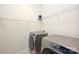 Functional laundry room with modern washer, dryer, and ample shelving space at 1035 Ivey Ct, Fort Mill, SC 29707