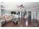 Open-concept living room with kitchen, dining area, and staircase access at 1035 Ivey Ct, Fort Mill, SC 29707