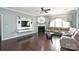 Cozy living room with hardwood floors, fireplace, and large windows at 1035 Ivey Ct, Fort Mill, SC 29707