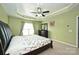 Main bedroom featuring a tray ceiling, carpet flooring, and natural light from the windows at 1035 Ivey Ct, Fort Mill, SC 29707