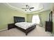 Comfortable main bedroom featuring tray ceilings, a ceiling fan, and carpet flooring at 1035 Ivey Ct, Fort Mill, SC 29707