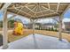 Covered patio overlooking a spacious backyard with a playset, ideal for relaxing and watching children play at 1035 Ivey Ct, Fort Mill, SC 29707