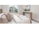 Stylish bedroom with large window allowing for natural light and neutral decor for a soothing space at 108 Sari St, Troutman, NC 28166