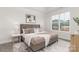 Sun-filled bedroom with a large window, soft carpet, and elegant furnishings for a serene and comfortable retreat at 108 Sari St, Troutman, NC 28166