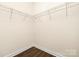 Walk-in closet features wire shelving and wood-look flooring at 108 Sari St, Troutman, NC 28166