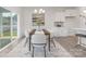 Elegant dining room featuring modern decor, a stylish chandelier, and a sliding glass door that fills the space with natural light at 108 Sari St, Troutman, NC 28166