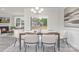 Inviting dining area with modern chandelier, wood table, and view into the living room, ideal for Gathering gatherings at 108 Sari St, Troutman, NC 28166