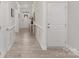 Bright hallway featuring classic molding details, light wood flooring, and an inviting entryway with a glimpse of the front door at 108 Sari St, Troutman, NC 28166