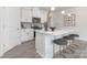 Stylish kitchen featuring a center island with seating, modern stainless steel appliances, and sleek white cabinetry at 108 Sari St, Troutman, NC 28166