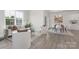 Open-concept living space featuring a modern sofa, stylish decor, and a dining area, perfect for comfortable living and entertaining at 108 Sari St, Troutman, NC 28166