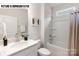 Bathroom features a tub with a shower and a vanity with modern fixtures at 110 Noah Ln, Troutman, NC 28166