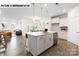 Modern kitchen with a center island, stainless steel appliances, and a connected living space at 110 Noah Ln, Troutman, NC 28166