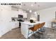 Well-appointed kitchen with a large island, modern appliances, and seamless flow to living area at 110 Noah Ln, Troutman, NC 28166