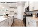 Sleek kitchen features an island with a sink, white cabinets, and modern stainless steel appliances at 110 Noah Ln, Troutman, NC 28166