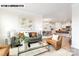 Open-concept living area with hardwood floors, comfortable furniture, and an adjacent kitchen at 110 Noah Ln, Troutman, NC 28166