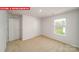 Neutral bedroom showcasing carpet, white walls, a window, and two doors at 11123 Cardinal Creek Ave, Charlotte, NC 28215
