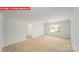 Spacious bedroom with neutral carpet and a window at 11123 Cardinal Creek Ave, Charlotte, NC 28215