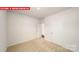 Bedroom featuring neutral carpet, white walls, with a closet and doorway at 11123 Cardinal Creek Ave, Charlotte, NC 28215