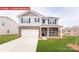 Charming two-story home with stone accents, a two-car garage, and a well-maintained lawn at 11123 Cardinal Creek Ave, Charlotte, NC 28215