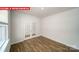 Bright, open living area featuring wood floors, a large window, and french doors at 11123 Cardinal Creek Ave, Charlotte, NC 28215
