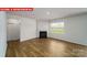 Bright living room with a cozy fireplace and wood-look flooring at 11123 Cardinal Creek Ave, Charlotte, NC 28215