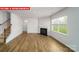 Open-concept living room featuring wood-look flooring and a fireplace at 11123 Cardinal Creek Ave, Charlotte, NC 28215
