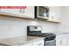 Close-up of a modern kitchen featuring stainless steel appliances, granite countertops and white subway tile backsplash at 11204 Cardinal Creek Ave, Charlotte, NC 28215