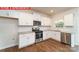 Modern kitchen features white cabinets, stainless steel appliances, granite countertops, and hardwood floors at 11204 Cardinal Creek Ave, Charlotte, NC 28215