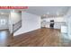 Spacious living room features hardwood floors, white walls, staircase, and connects to the kitchen and front door at 11204 Cardinal Creek Ave, Charlotte, NC 28215
