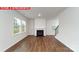 Bright living room with a cozy fireplace, large windows offering natural light, and hardwood flooring at 11204 Cardinal Creek Ave, Charlotte, NC 28215