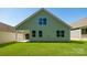 Back view of a green house with lawn and blue sky at 119 Noah Ln, Troutman, NC 28166