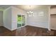 Bright dining room showcasing dark hardwood floors, paneled walls, large sliding glass doors, and elegant lighting at 119 Noah Ln, Troutman, NC 28166