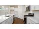 Bright kitchen boasting quartz countertops, modern stainless appliances, stylish backsplash, and dark wood-look floors at 119 Noah Ln, Troutman, NC 28166