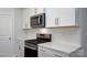 Modern kitchen with stainless steel appliances, stylish backsplash, quartz countertops, and light wood-look floors at 119 Noah Ln, Troutman, NC 28166