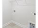 An interior view of laundry room with tile flooring, shelves and utilities at 119 Noah Ln, Troutman, NC 28166