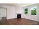 Spacious living room with fireplace, large windows, crown molding, and beautiful hardwood floors at 119 Noah Ln, Troutman, NC 28166