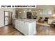 Bright, open kitchen with a center island, stainless steel appliances, and view into the living room at 121 Noah Ln, Troutman, NC 28166