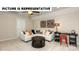 Comfortable living room featuring neutral carpet, modern decor, and a white sectional sofa at 121 Noah Ln, Troutman, NC 28166