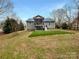 View of the backyard showing a well-maintained lawn and a back deck, perfect for outdoor entertaining and relaxation at 121 Purple Finch Ln, Mooresville, NC 28117