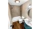 Modern bathroom featuring tile surround tub, updated sink and fixtures, and wood-look flooring at 121 Purple Finch Ln, Mooresville, NC 28117