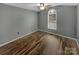 A cozy bedroom featuring hardwood flooring, neutral walls, and a window that allows plenty of natural light at 121 Purple Finch Ln, Mooresville, NC 28117