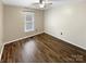 Bright bedroom with ceiling fan, neutral walls, window with blinds, and wood-look flooring at 121 Purple Finch Ln, Mooresville, NC 28117