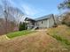 Exterior back elevation of home with deck, patio, backyard and vinyl siding at 121 Purple Finch Ln, Mooresville, NC 28117