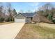 Charming home featuring a combination of stone and vinyl siding, complemented by an attached two-car garage and a well-manicured lawn at 121 Purple Finch Ln, Mooresville, NC 28117