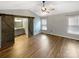 Serene primary bedroom featuring hardwood floors, a ceiling fan, a window providing natural light, and a sliding barn door at 121 Purple Finch Ln, Mooresville, NC 28117