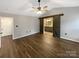 Spacious main bedroom with barn door to ensuite bath, vaulted ceiling, and wood-look flooring at 121 Purple Finch Ln, Mooresville, NC 28117